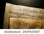 Pages of the United States Constitution showing We The People heading and Declaration of Independence.