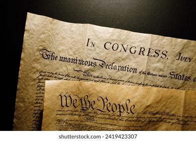 Pages of the United States Constitution showing We The People heading and Declaration of Independence. - Powered by Shutterstock