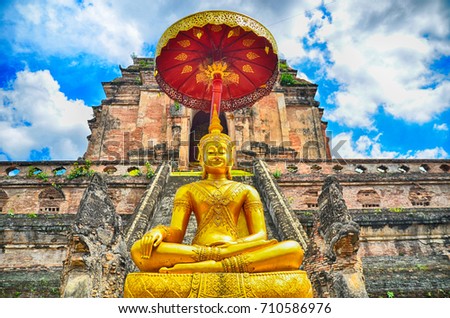 Pagoda and buddha statue at Wat Chedi Luang temple in Chiang Mai  Thailand