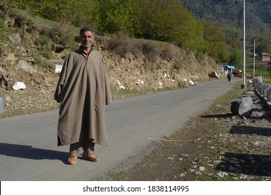 Pahalgam, Kashmir/India-26.04.18: An handsome kashmiri man in phiran the traditional dress standing on the road.