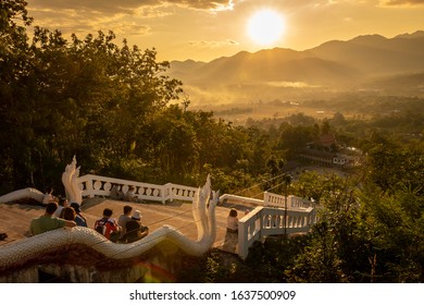 Pai, Thailand on November 22, 2019: Tourists watch the sunset from White Buddha in Chedi Phra That Mae Yen, Pai, Thailand