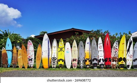 PAIA, HI -30 MARCH 2015- Editorial: Colorful surfboards are lined up in the streets of Maui. Hawaii is the birthplace of modern surfing and home to the world's major big wave surfing competitions.