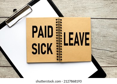 Paid Sick Leave. Text On An Open Notepad On The Table. On A Black Folder With A Clip