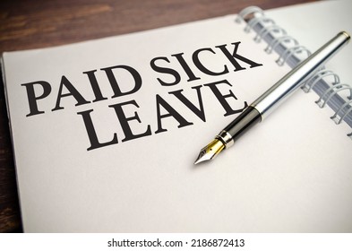 Paid Sick Leave Words On White Notepad And Pen