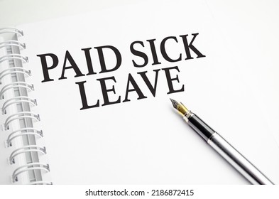 Paid Sick Leave Words On White Notepad And Pen