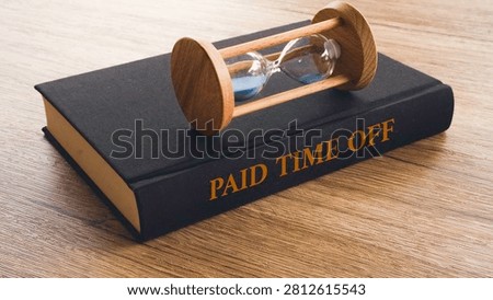 Paid Time Off Text on Book Cover with Hourglass