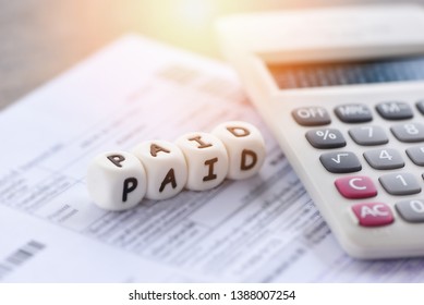 Paid Words And Calculator On Invoice Bill Paper For Time Paid Payment At Office Business Finances