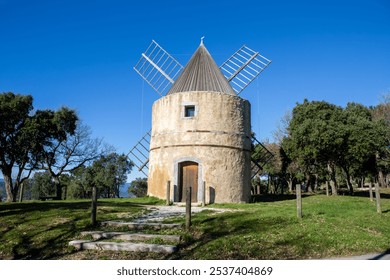 Paillas windmill surrounded by oaks, in Ramatuelle, in France, Europe, Provence.  - Powered by Shutterstock