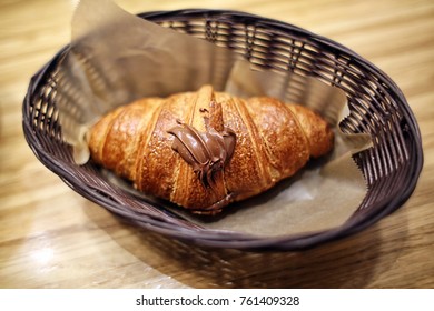 Pain Au Chocolate Croissant With Nutella Heart Design On Top In Basket At Cafe