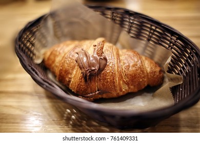 Pain Au Chocolate Croissant With Nutella Heart On Top In Basket At Cafe