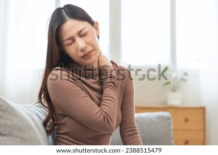Pain body muscles stiff problem, suffer asian young woman, girl painful with back, holding neck ache from work hand holding massaging rubbing shoulder hurt, sore sitting on couch at home. Health care