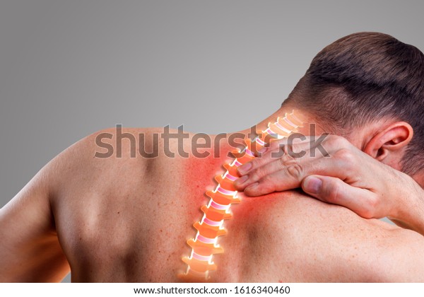 Pain in the
cervical spine. Symptom of cervical chondrosis. Inflammation of the
vertebra. On a gray
background.