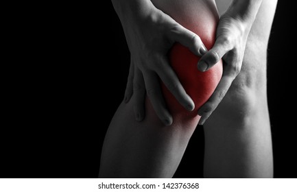 pain in the knee. Chiropractor doing massage in sick knee in black red color