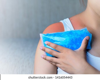 The pain in the neck and shoulder muscles is alleviated by cold compresses with cool gel.    - Shutterstock ID 1416054443