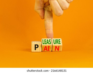 Pain or pleasure symbol. Concept words Pain or Pleasure on wooden cubes. Businessman hand. Beautiful orange table orange background. Business and pain or pleasure concept. Copy space.