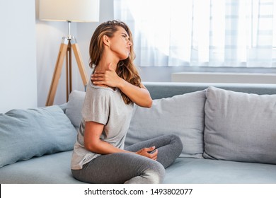 Pain in the shoulder. Upper arm pain, People with body-muscles problem, Healthcare And Medicine concept. Attractive woman sitting on the bed and holding painful shoulder with another hand. - Shutterstock ID 1493802077