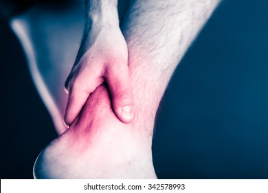 Painful leg and ankle, foot in pain, physical injury. Male leg and muscle pain from illness or accident, running or training, sport physical injuries when working out. Man athlete with painful leg.