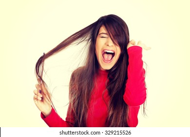 Painful Woman Combing Her Tangled Hair.