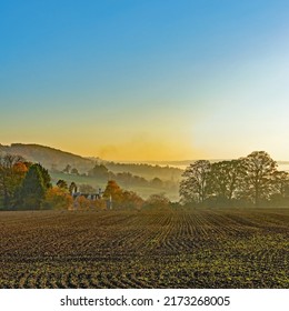 Painswick, Gloucestershire, UK, October 28th, 2015, A Golden Sunset Over A Ploughed Field And An Isolated Cottage In Autumn.