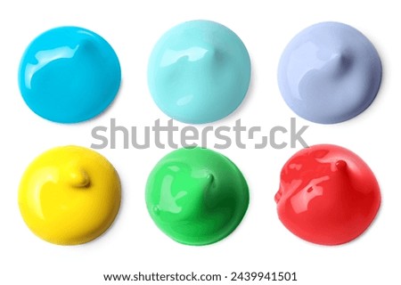 Paint blobs of different colors on white background, top view