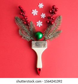 Paint Brush With Christmas Decoration Abstract On Red Background.