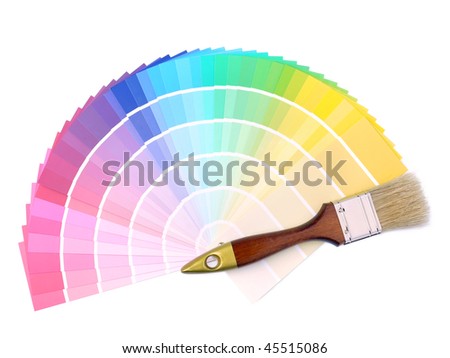 Paint brush on array of different paint color swatches