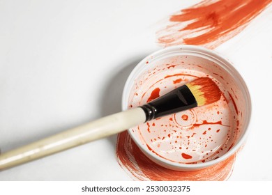 Paint brush on top of paint can with red paint on white background. - Powered by Shutterstock