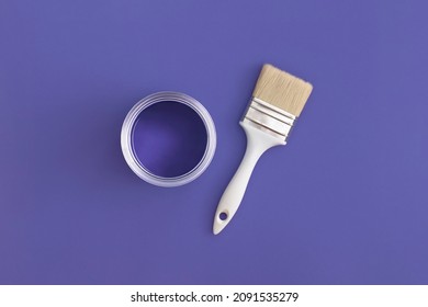Paint brush and an open can paint trendy Very Peri background  Color the year 2022  Top view  flat lay 