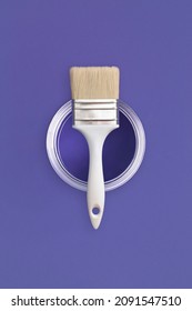 Paint brush and an open can paint trendy Very Peri background  Color the year 2022  Top view  flat lay 