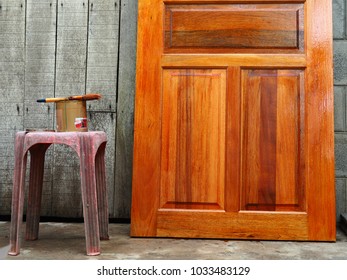 Paint Brush And Wood Paint On The Old Chair Near Wood Door Front Of Wall Vintage Outdoor,Art Of Color Paint Vintage