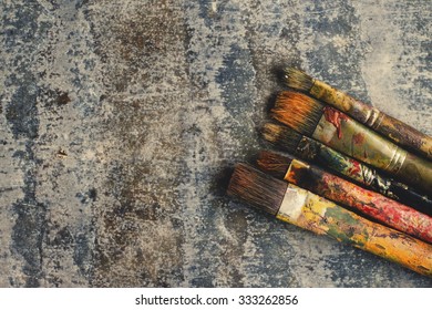 Paint Brushes. Aged Metal Background. 