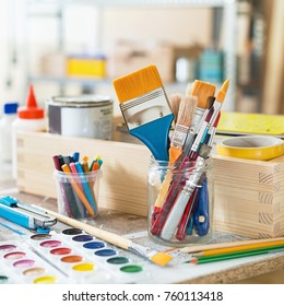 Paint Brushes And Crafting Supplies On The Table In A Workshop.