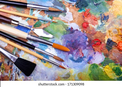 paint brushes on a palette  - Shutterstock ID 171309098