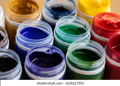 
Paint brushes and watercolor paints,  tempera paints on the table in a workshop, selective focus, close up, on wooden background. Set of gouache - bouquet.  - Shutterstock ID 1618127353