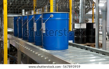 Paint bucket on conveyor. Fragment paint factory