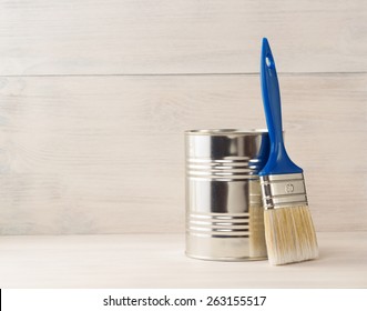 paint bucket and paintbrush  on wooden background