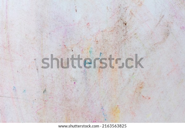 Paint of different colors on the\
wall. Stained white wall after child\'s drawing with\
crayons