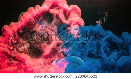 Paint drop. Ink water. Explosion smoke. Blue pink color fluid splash vapor cloud on glitter dust texture black abstract art background.