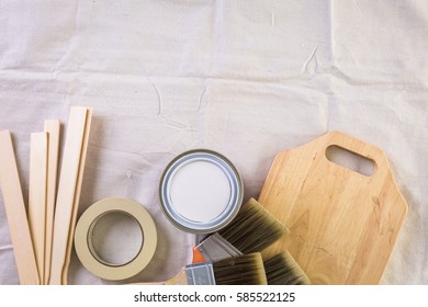 Paint In Metal Paint Can And Painters Tools On A Canvas Drop Cloth.