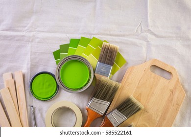 Paint In Metal Paint Can And Painters Tools On A Canvas Drop Cloth.