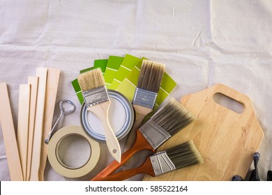 Paint In Metal Paint Can And Painters Tools On A Canvas Drop Cloth.