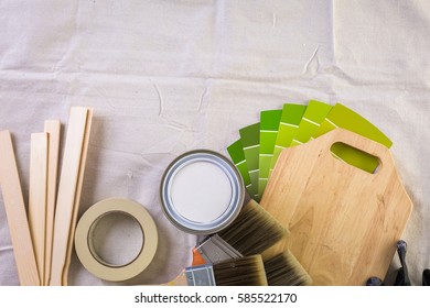 Paint In Metal Paint Can And Painters Tools On A Canvas Drop Cloth.