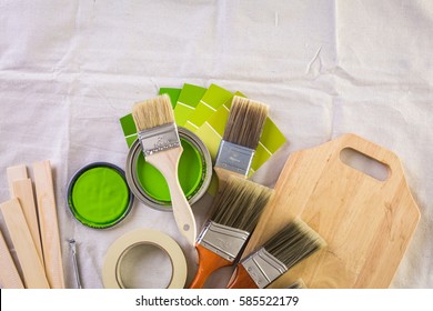 Paint In Metal Paint Can And Painters Tools On A Canvas Drop Cloth.