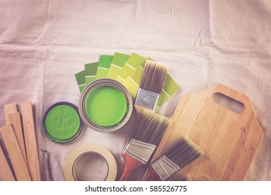 Paint In Metal Paint Can And Painters Tools On A Canvas Drop Cloth.