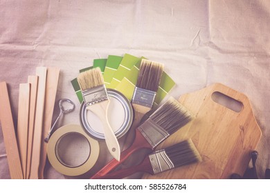 Paint In Metal Paint Can And Painters Tools On A Canvas Drop Cloth.