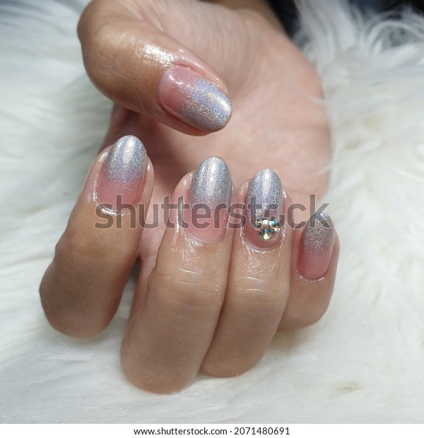 Paint nails with ombre, holographic colors and\
diamonds for a luxurious\
look.