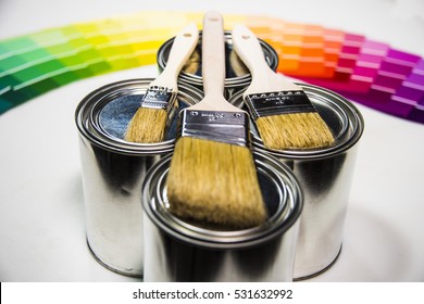 Paint Pot Samples With Brushes On It And Color Samples In Backgrpund