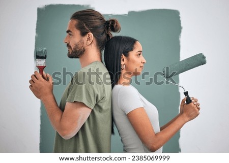 Paint, renovate and diy with a couple in their home for painting, redecorating or improvement. House, interior and room with a man and woman painting a wall in their apartment for renovation [[stock_photo]] © 