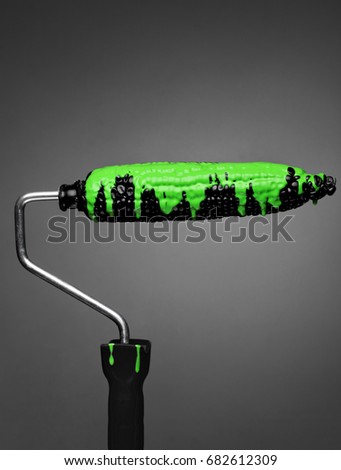 Paint Roller black corn with pouring green toxic paint on gray background. Fashion food concept.Creative advertising of paint.