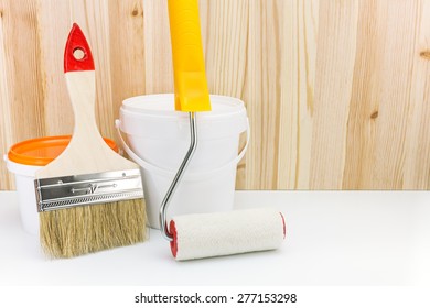 paint roller with brush and paint can against wooden boards - Shutterstock ID 277153298